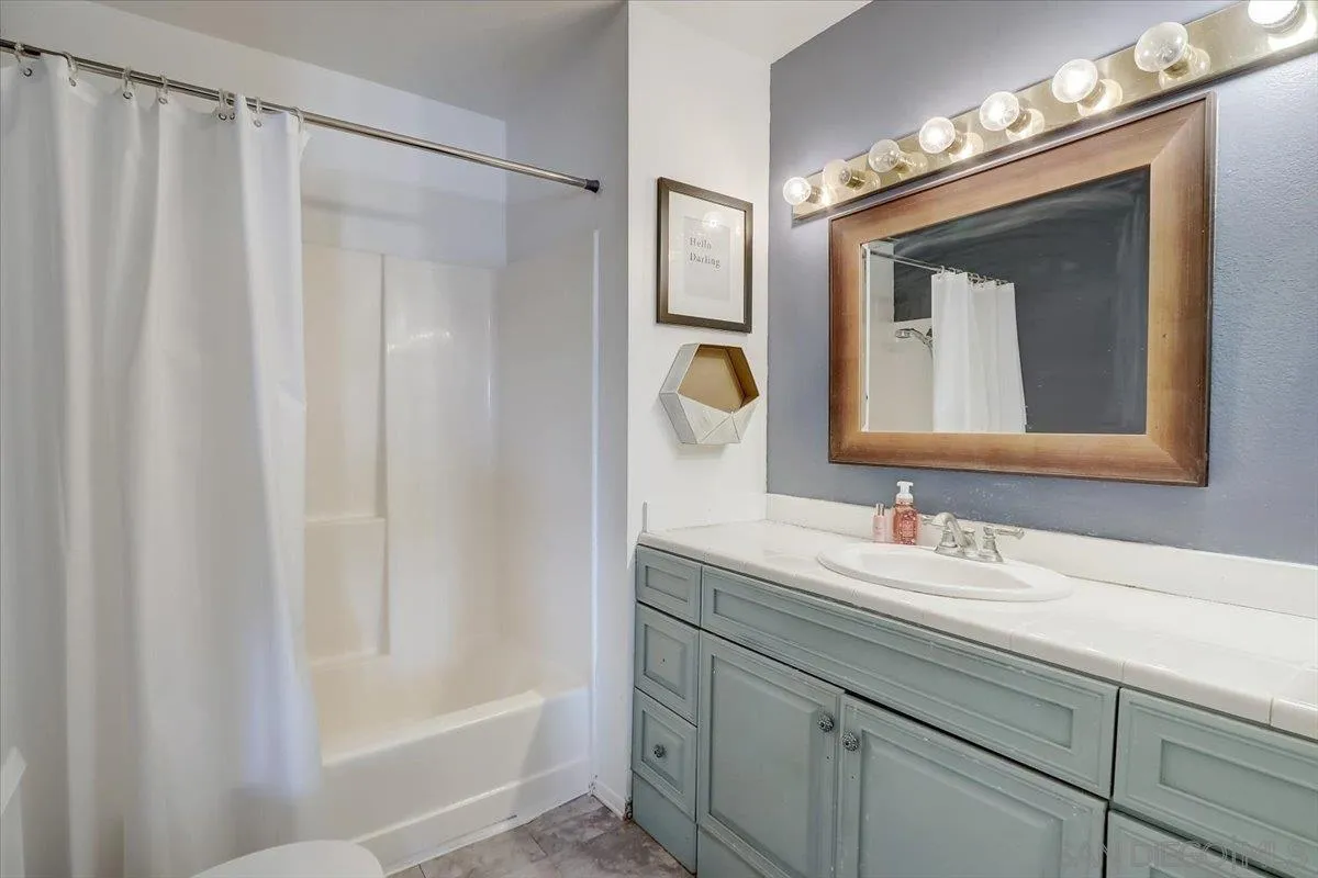 4094 Tambor Road San Diego, CA 92124 - Photo 28 of 49 a bathroom with a double vanity sink and a mirror
