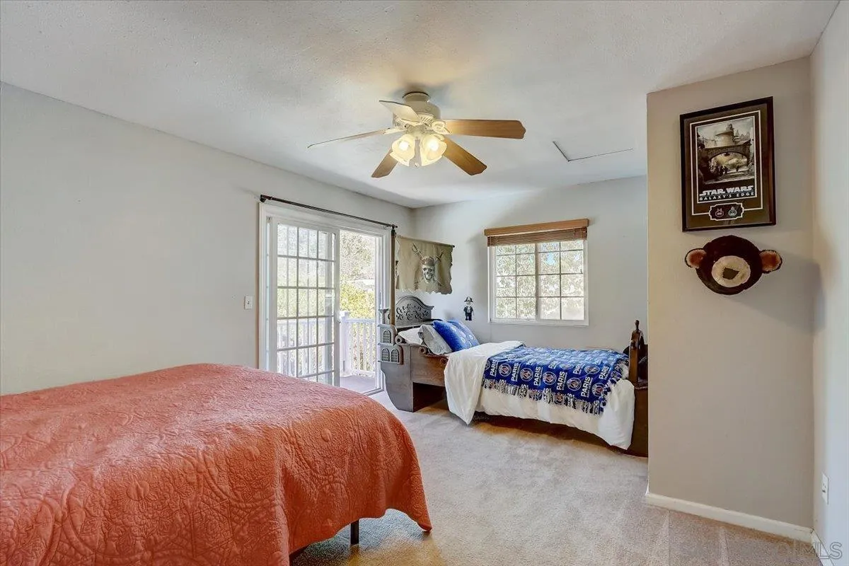 4094 Tambor Road San Diego, CA 92124 - Photo 29 of 49 a spacious bedroom with a bed and a window