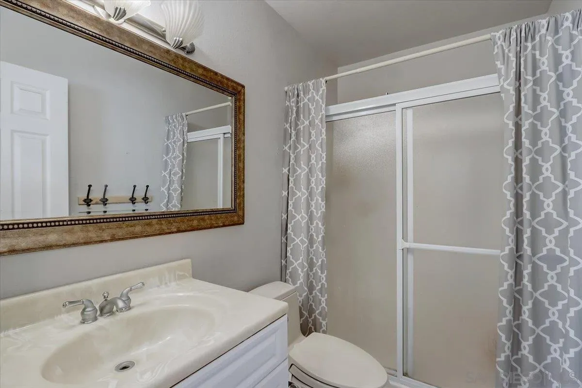 4094 Tambor Road San Diego, CA 92124 - Photo 34 of 49 a bathroom with a sink and a mirror