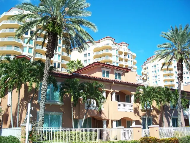a front view of a house with a palm tree