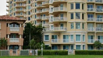 a front view of a building with a garden