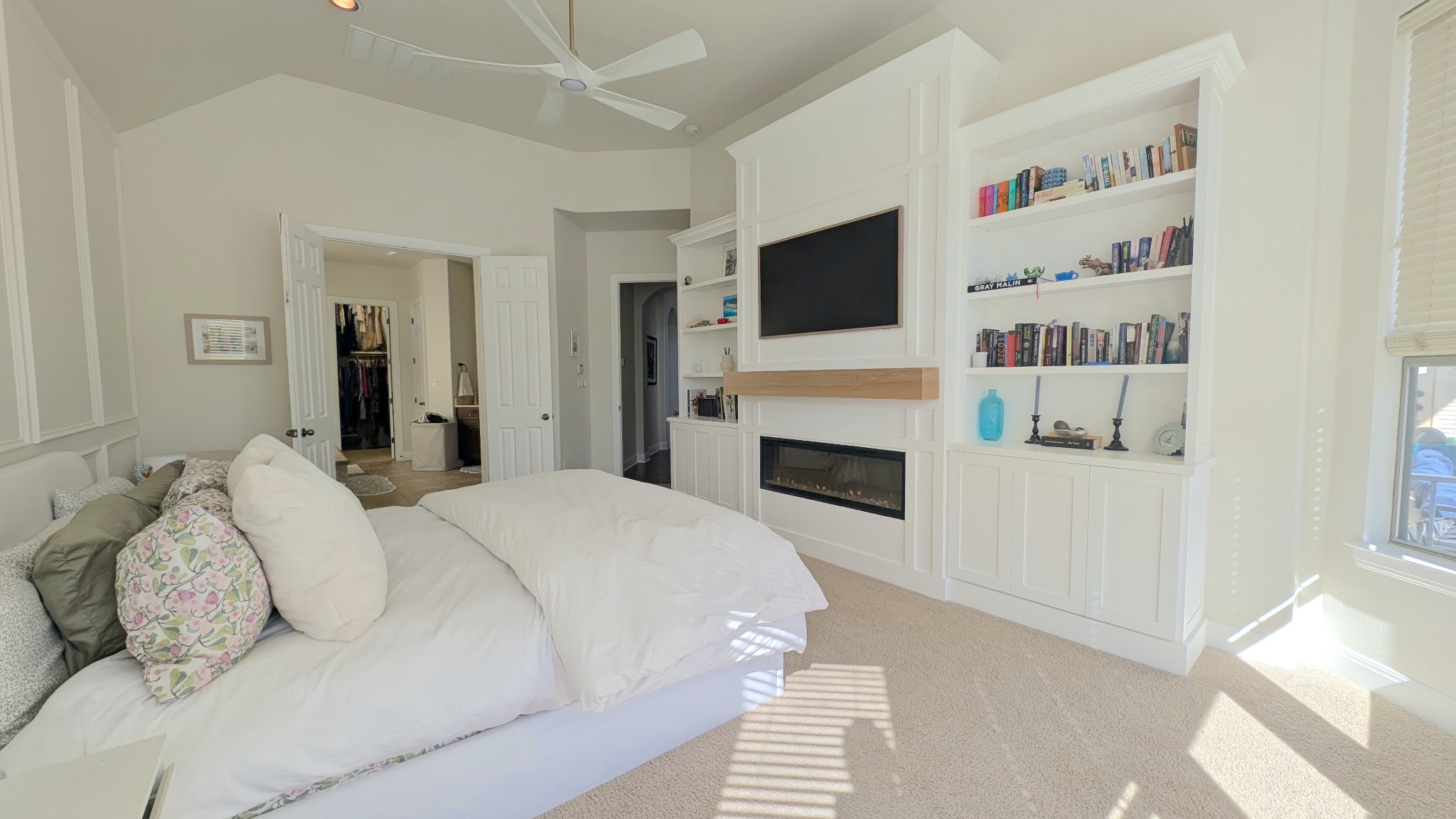 4205 Vail Divide Bee Cave, TX 78738 - Photo 13 of 28 Bedroom featuring a glass-covered fireplace and custom-built shelves with high ceiling