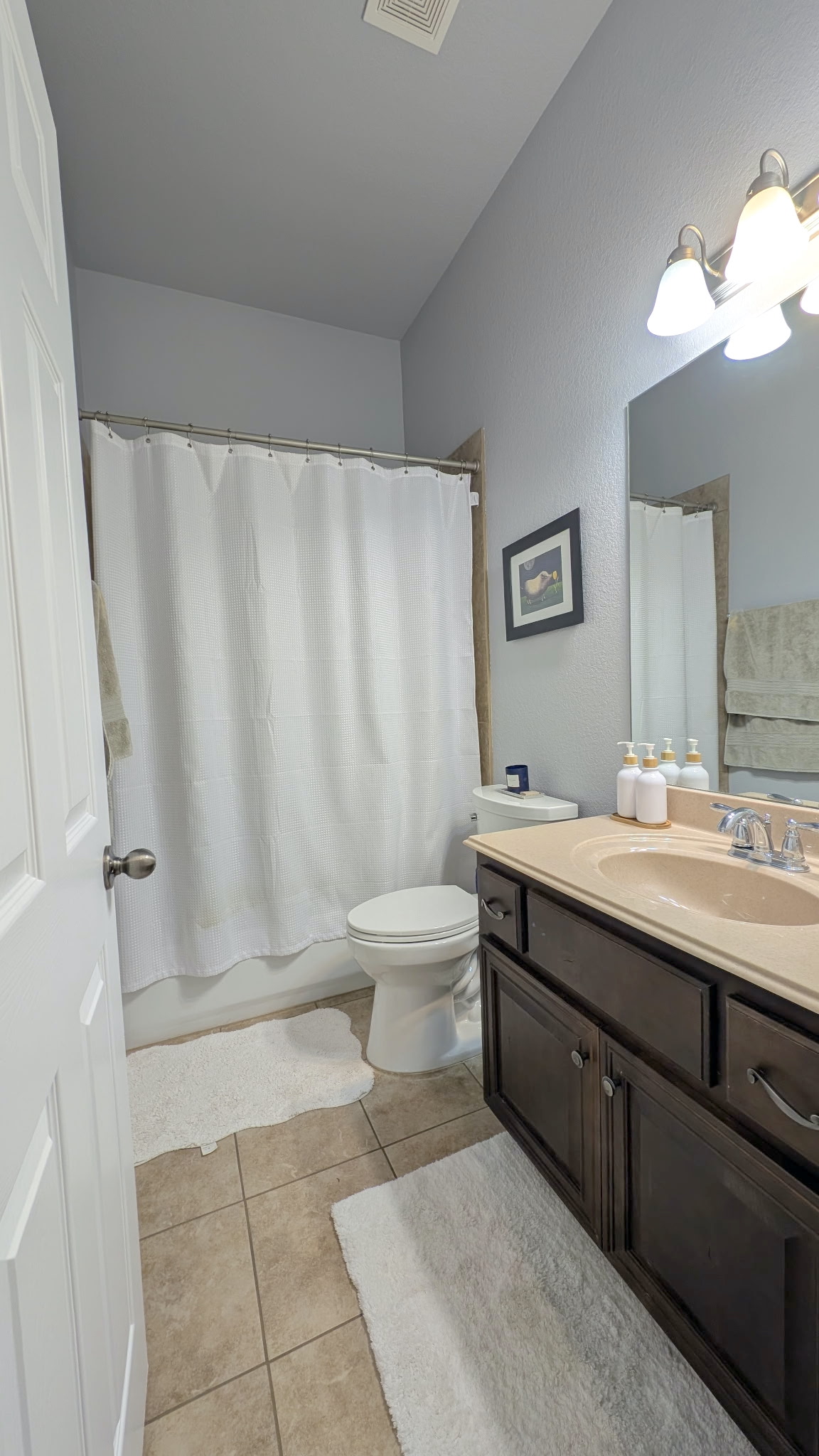 4205 Vail Divide Bee Cave, TX 78738 - Photo 20 of 28 Bathroom featuring vanity, light tile patterned floors, and shower / tub combo