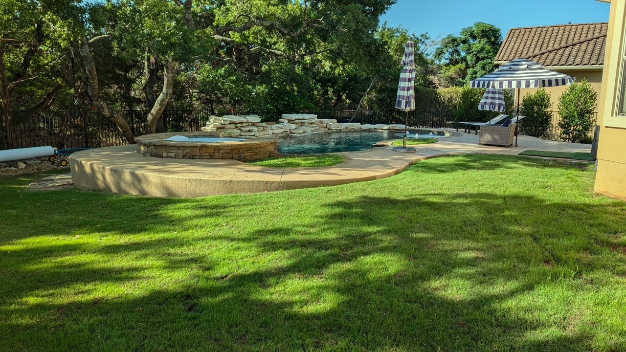4205 Vail Divide Bee Cave, TX 78738 - Photo 24 of 28 View of green lawn with a patio area and a pool with connected spa jacuzzi