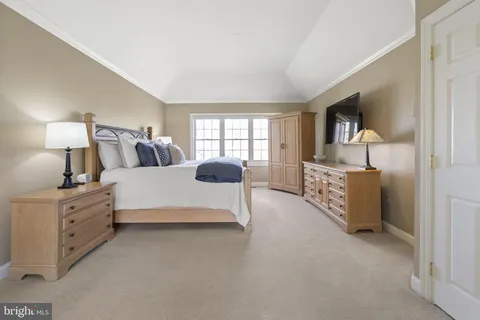 a spacious bedroom with a bed and a window