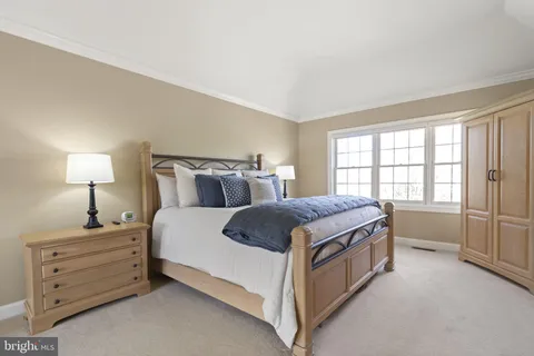 a view of a bedroom with furniture and window