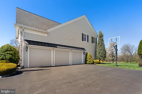 a view of a house with a garage and yard