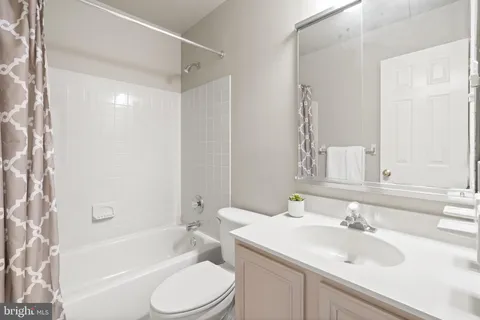 a spacious bedroom with a bed and a flat screen tv