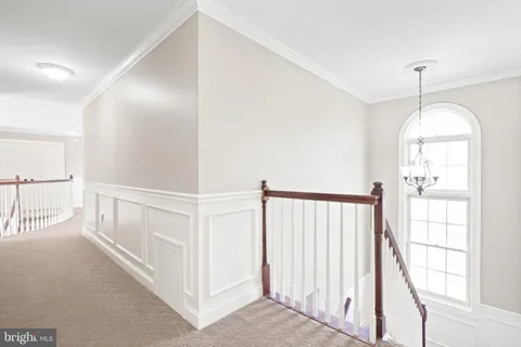 a living room with stairs and furniture