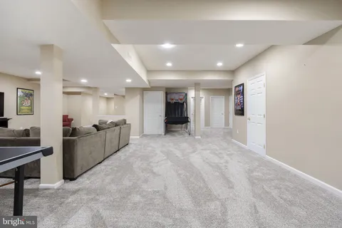 a room with furniture and a air conditioner vent