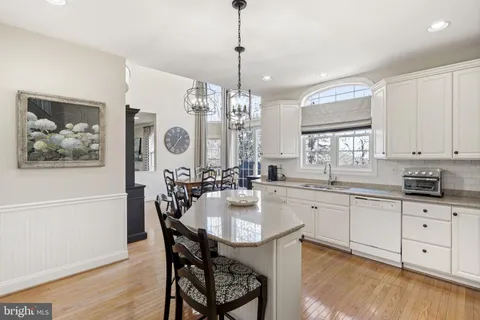 a kitchen with center island table and chairs