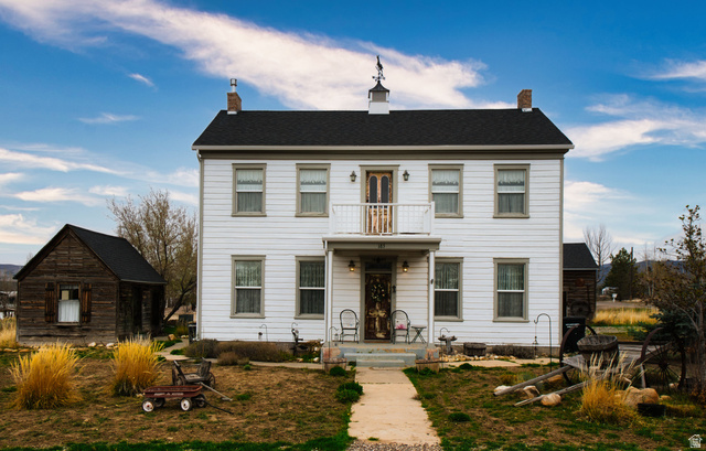 183 East 300 North Mount Pleasant, UT 84647 - Photo 1 of 1 View of front of home with a chimney, an outdoor structure, and a balcony