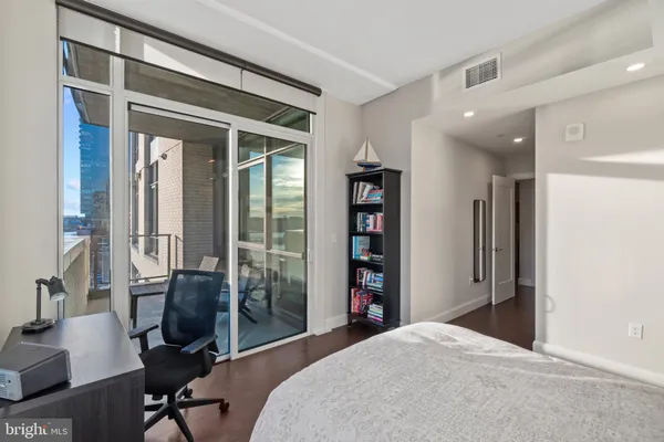 a bedroom with a bed and a desk