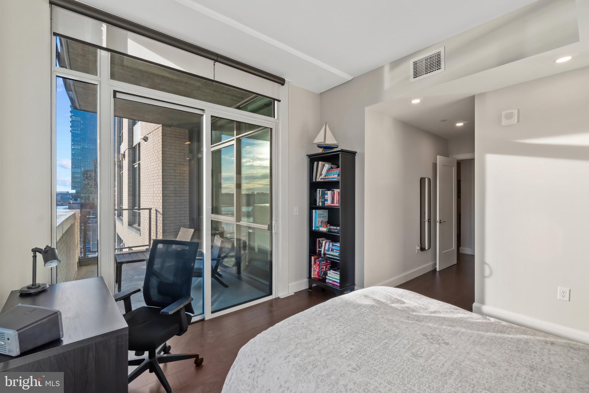 1330 Lancaster Street, Unit C602 Baltimore, MD 21231 - Photo 13 of 28 a bedroom with a bed and a desk