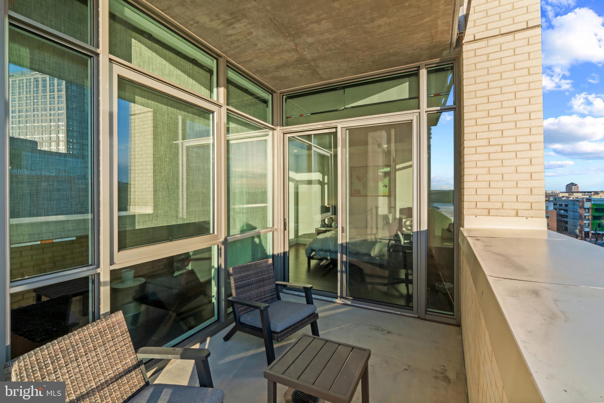 1330 Lancaster Street, Unit C602 Baltimore, MD 21231 - Photo 14 of 28 a balcony with furniture and wooden floor
