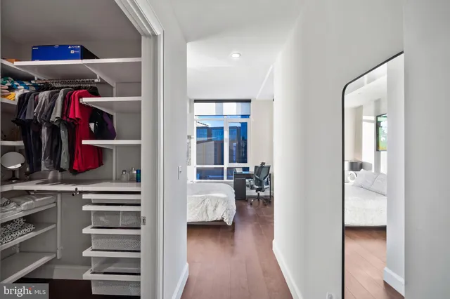 a view of walk in closet with clothes and shoes