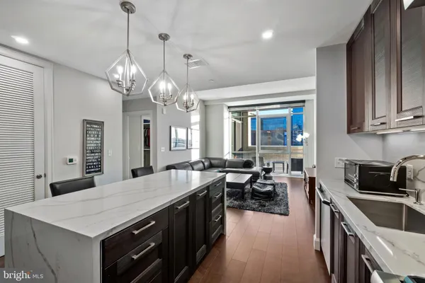 a large kitchen with kitchen island a stove a sink a dining table and chairs