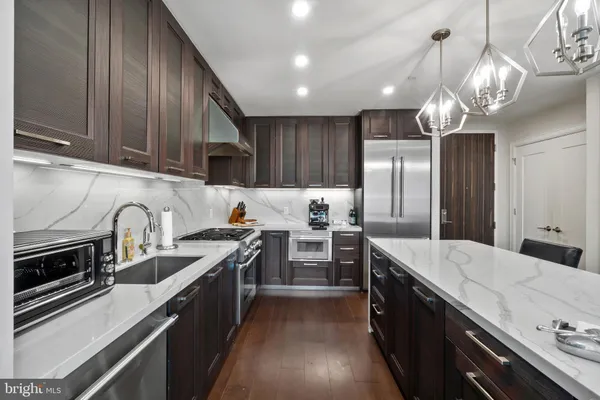 a open kitchen with stainless steel appliances granite countertop a sink stove and refrigerator