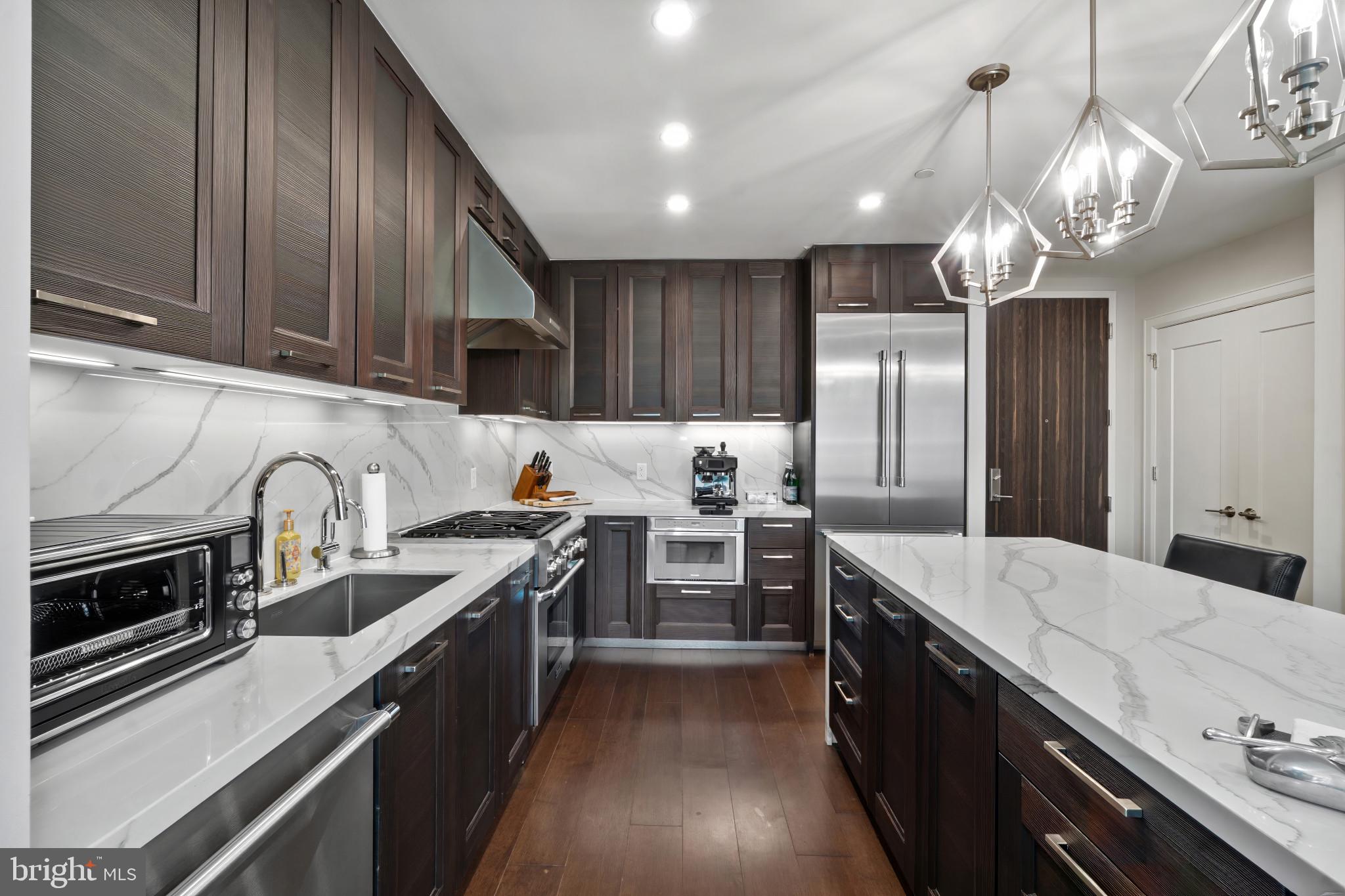 1330 Lancaster Street, Unit C602 Baltimore, MD 21231 - Photo 5 of 28 a open kitchen with stainless steel appliances granite countertop a sink stove and refrigerator