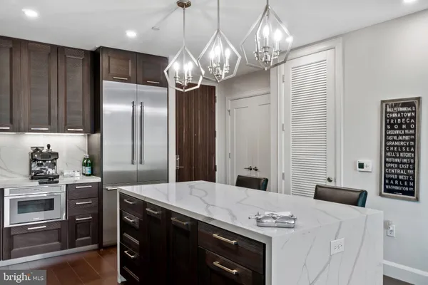 a kitchen with stainless steel appliances a stove a refrigerator a sink and dishwasher