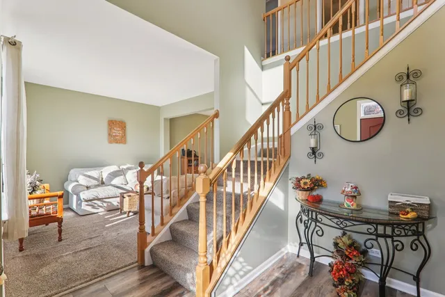 a living room with furniture and a view of kitchen