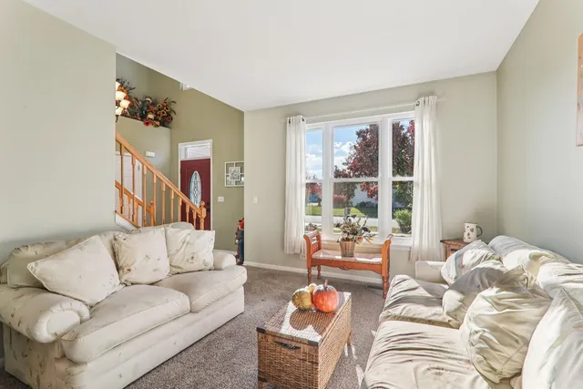a view of a dining room with furniture and chandelier