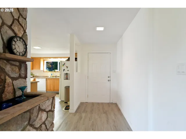 a open kitchen with white cabinets and wooden floor