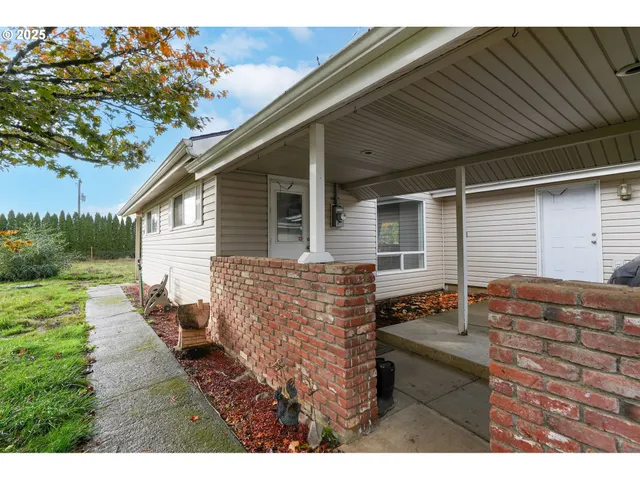 a backyard of a house with outdoor seating