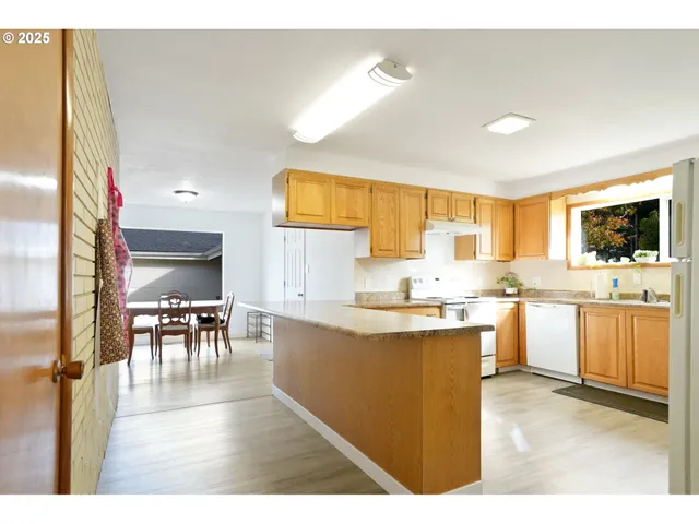 a kitchen with microwave a stove and cabinets