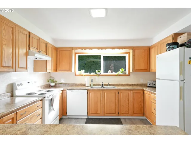 a kitchen with a sink stove and refrigerator