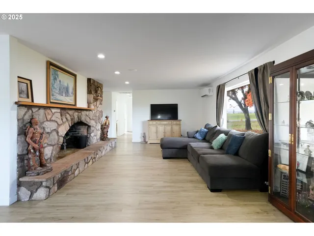 a living room with furniture flat screen tv and a fireplace