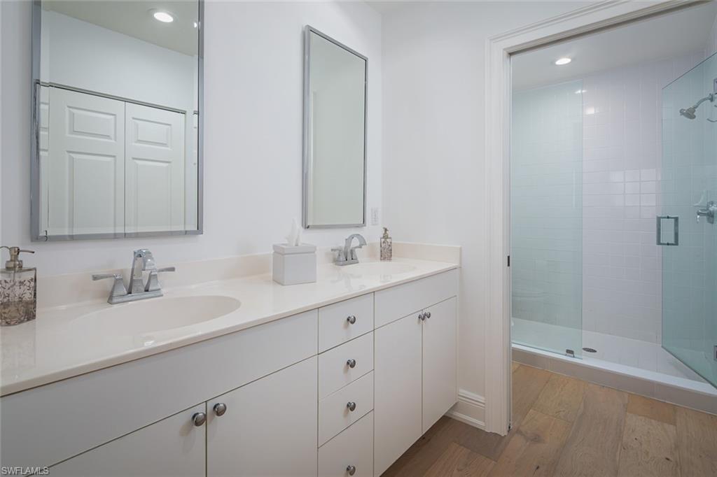 470 Launch Circle, Unit V401 Naples, FL 34108 - Photo 12 of 32 a bathroom with double sink and a mirror