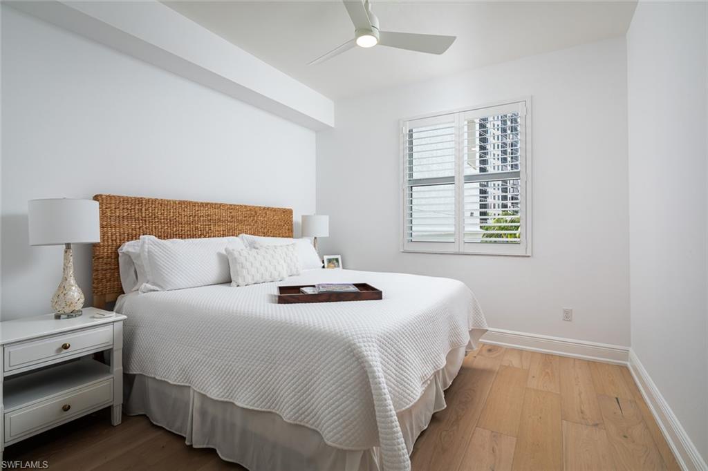 470 Launch Circle, Unit V401 Naples, FL 34108 - Photo 13 of 32 a bedroom with a bed and a window