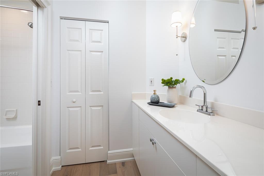 470 Launch Circle, Unit V401 Naples, FL 34108 - Photo 14 of 32 a bathroom with a sink and a mirror