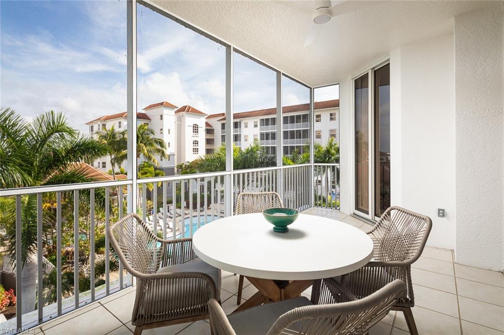 470 Launch Circle, Unit V401 Naples, FL 34108 - Photo 17 of 32 a view of a dining room with furniture window and wooden floor