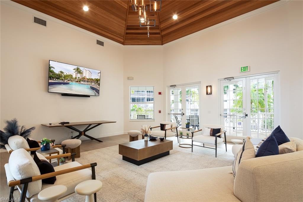 470 Launch Circle, Unit V401 Naples, FL 34108 - Photo 19 of 32 a living room with furniture and a chandelier