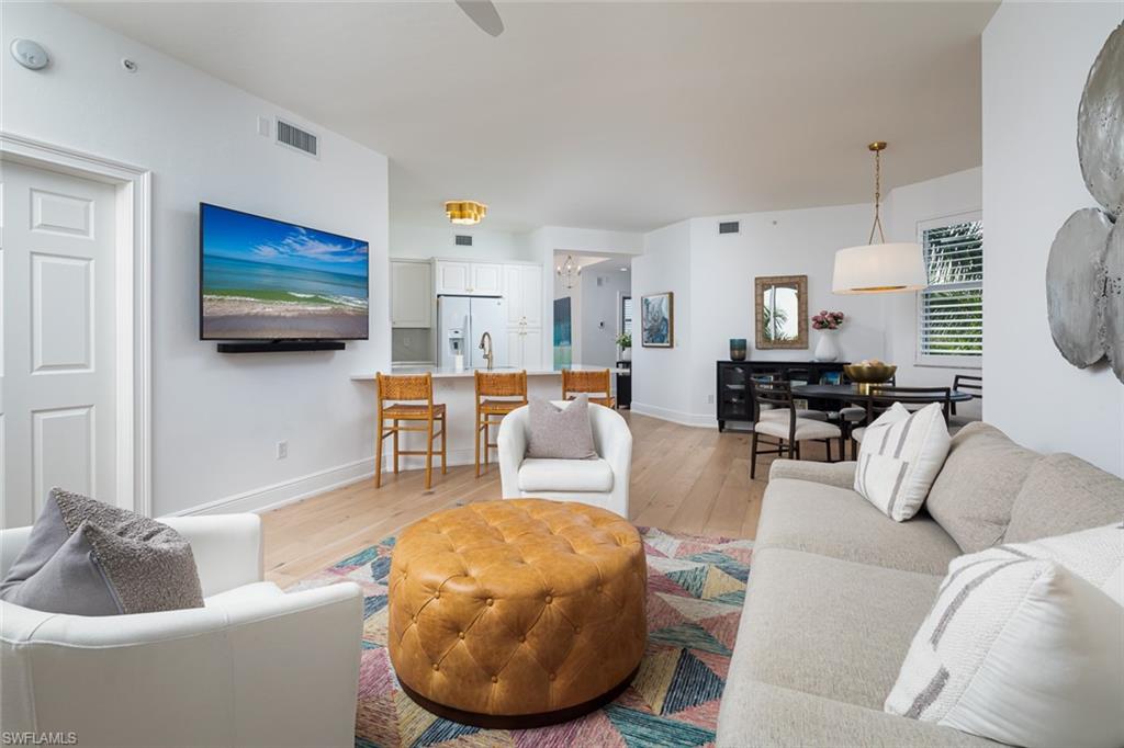 470 Launch Circle, Unit V401 Naples, FL 34108 - Photo 4 of 32 a living room with furniture and a flat screen tv