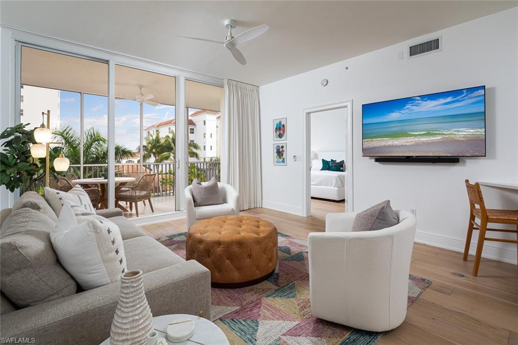 470 Launch Circle, Unit V401 Naples, FL 34108 - Photo 5 of 32 a living room with furniture and a large window