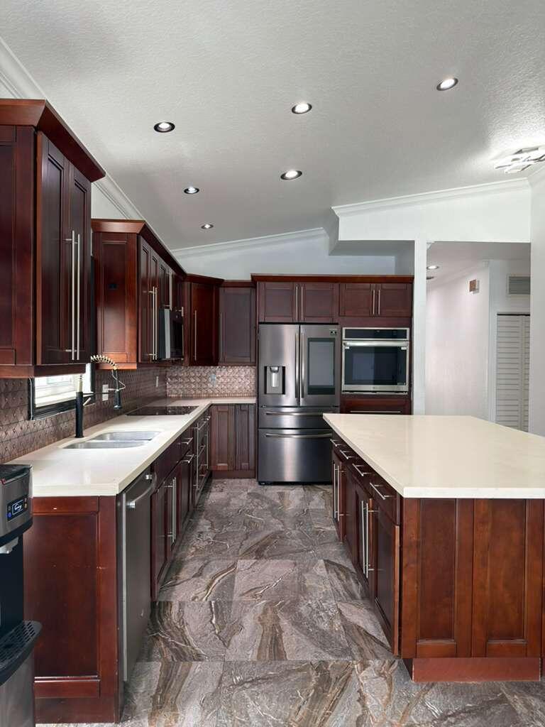 4572 Southwest 14th Street Deerfield Beach, FL 33442 - Photo 20 of 81 a large kitchen with stainless steel appliances a sink and a stove
