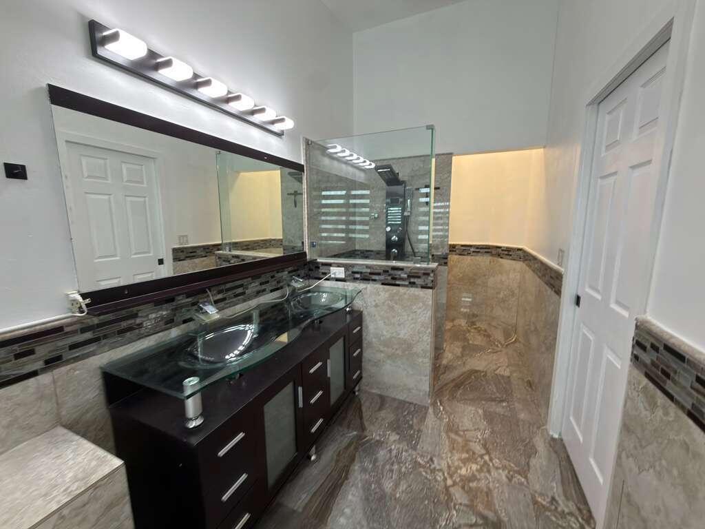 4572 Southwest 14th Street Deerfield Beach, FL 33442 - Photo 32 of 81 a bathroom with a sink a vanity and a mirror