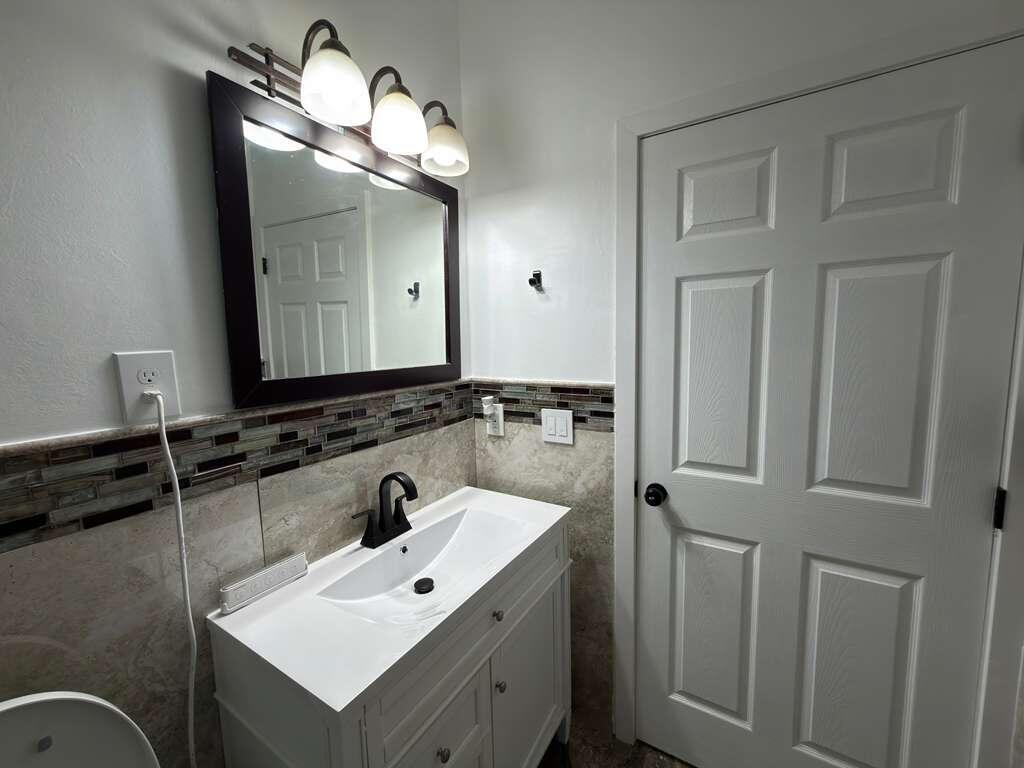 4572 Southwest 14th Street Deerfield Beach, FL 33442 - Photo 38 of 81 a bathroom with a sink and a mirror