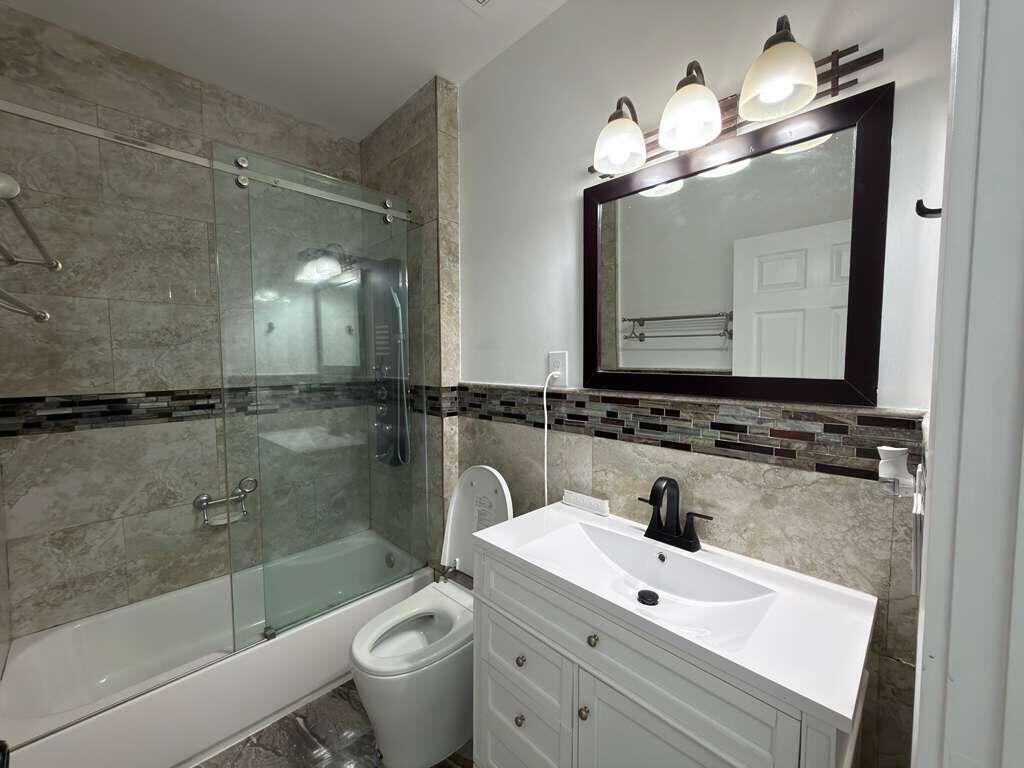 4572 Southwest 14th Street Deerfield Beach, FL 33442 - Photo 39 of 81 a bathroom with a sink a toilet and a mirror
