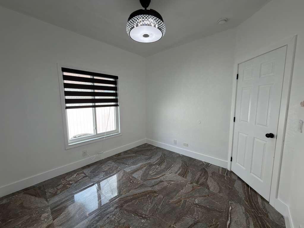 4572 Southwest 14th Street Deerfield Beach, FL 33442 - Photo 42 of 81 an empty room with a window and wooden floor