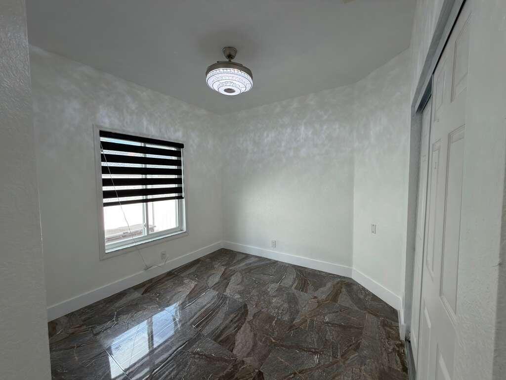 4572 Southwest 14th Street Deerfield Beach, FL 33442 - Photo 51 of 81 a view of empty room with windows