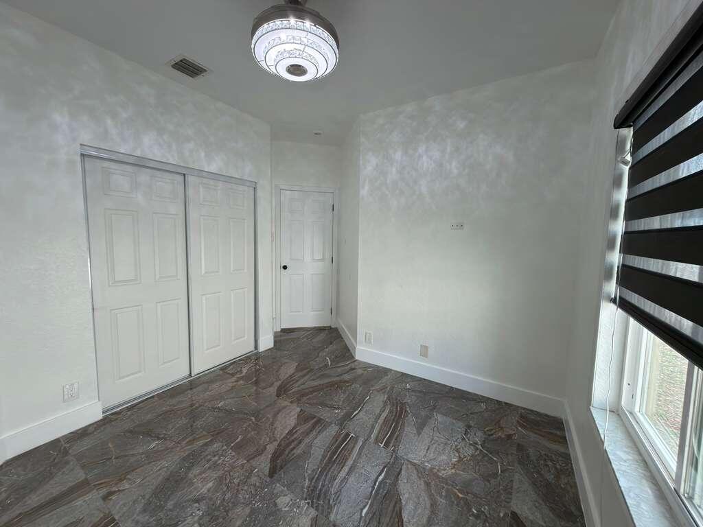 4572 Southwest 14th Street Deerfield Beach, FL 33442 - Photo 52 of 81 an empty room with windows