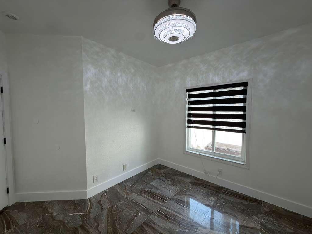4572 Southwest 14th Street Deerfield Beach, FL 33442 - Photo 53 of 81 an empty room with a chair