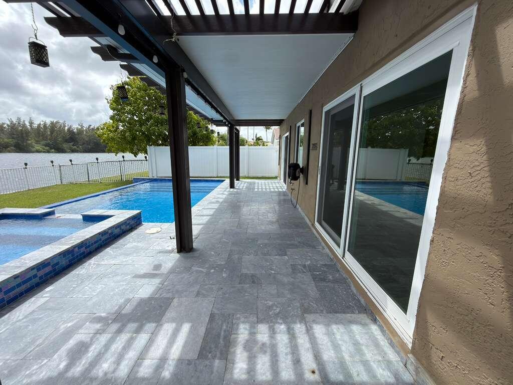 4572 Southwest 14th Street Deerfield Beach, FL 33442 - Photo 62 of 81 a view of a patio with wooden floor and outer view