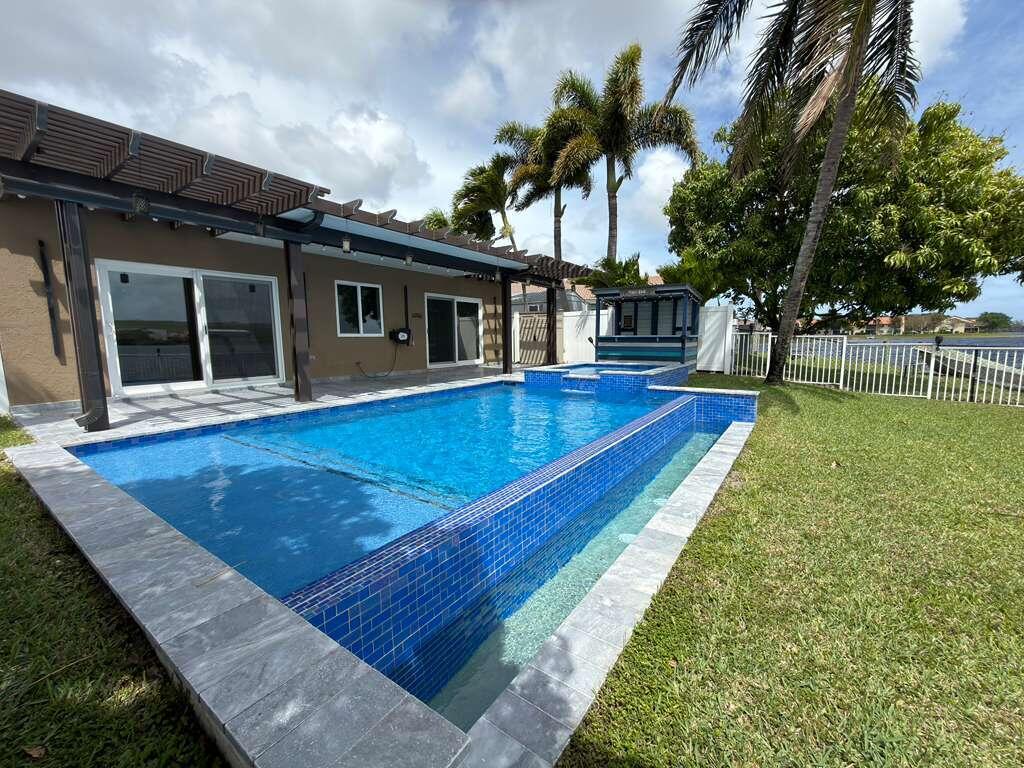 4572 Southwest 14th Street Deerfield Beach, FL 33442 - Photo 66 of 81 a view of a house with a swimming pool