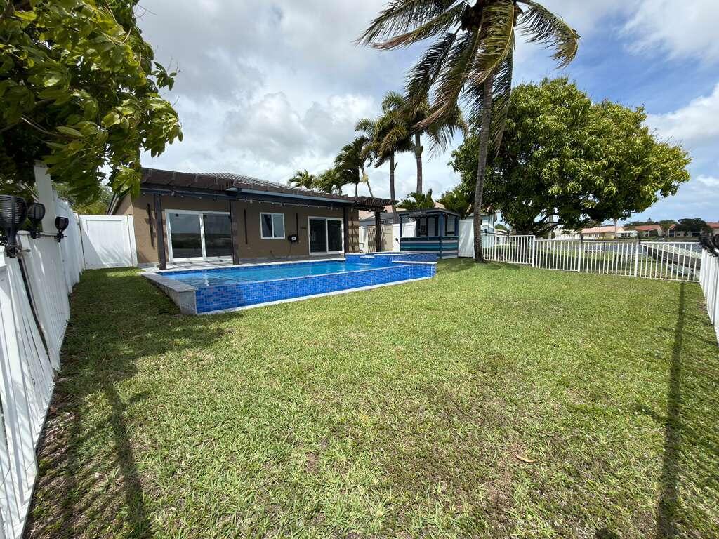 4572 Southwest 14th Street Deerfield Beach, FL 33442 - Photo 69 of 81 a view of a house with a backyard