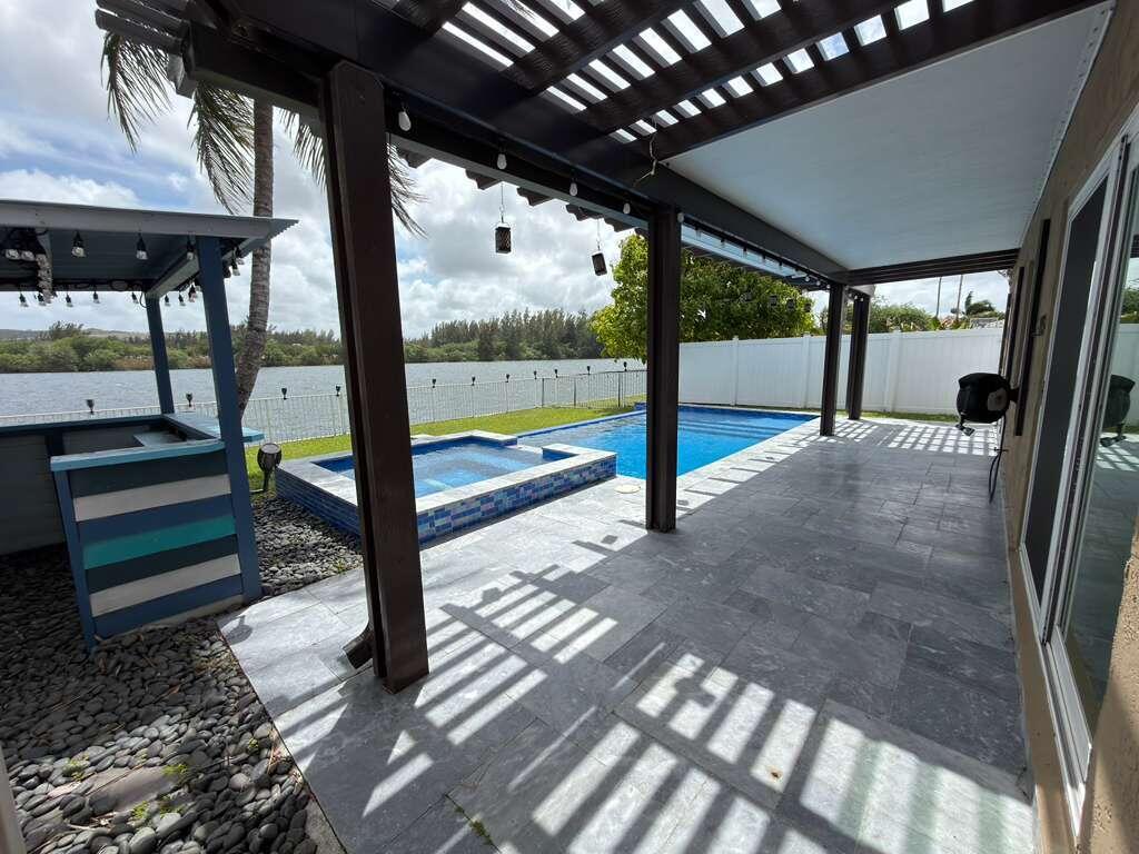 4572 Southwest 14th Street Deerfield Beach, FL 33442 - Photo 71 of 81 a view of a porch with furniture and a yard